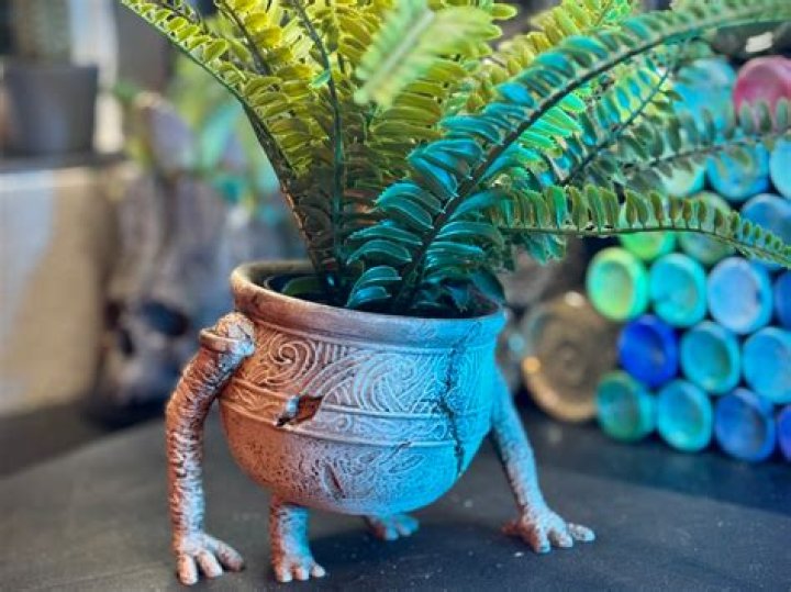 A 3D printed Pot Boy from Elden Ring, with a die on its cauldron cover