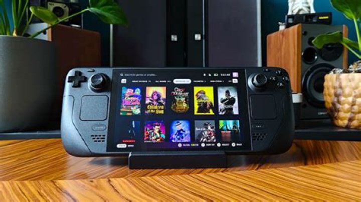 A Steam Deck sitting on Valve’s Deck docking station, displaying the Steam OS interface