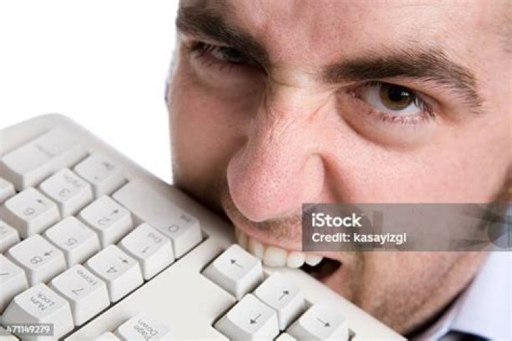 Man Biting Keyboard
