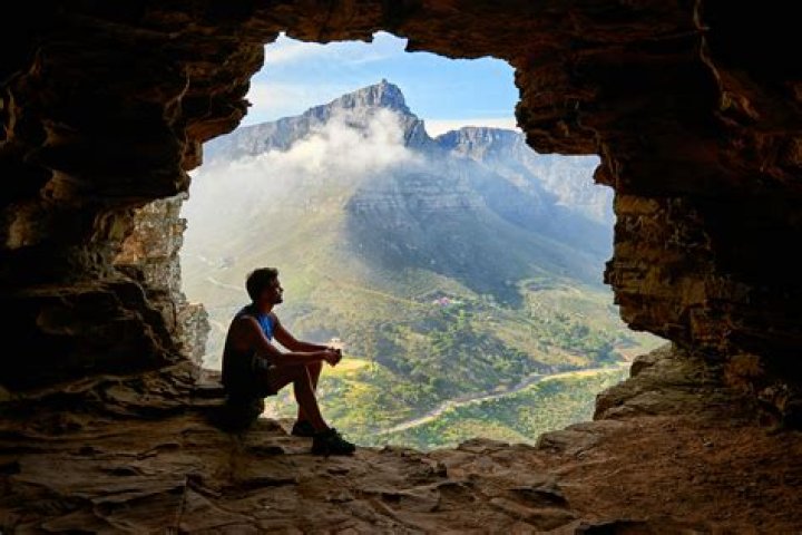 Man sitting in a cave.