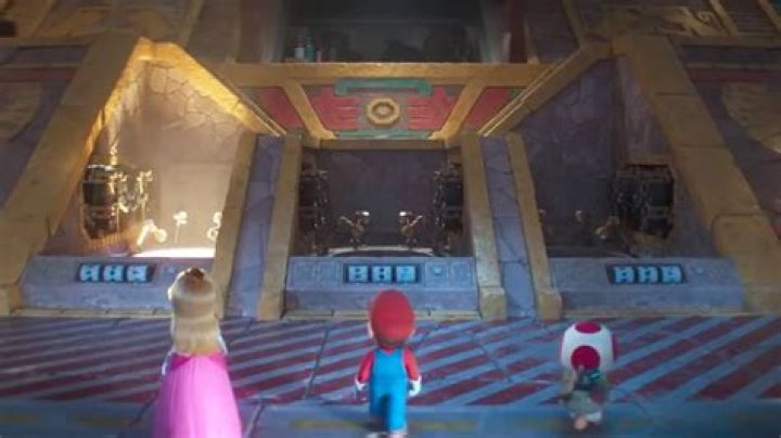 Peach, Mario and Toad approach a garage bay in The Super Mario Bros Movie, where they are about to pick their karts for a race