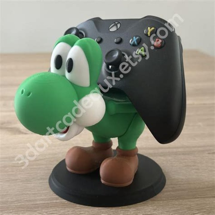 Yoshi P holds xbox controller